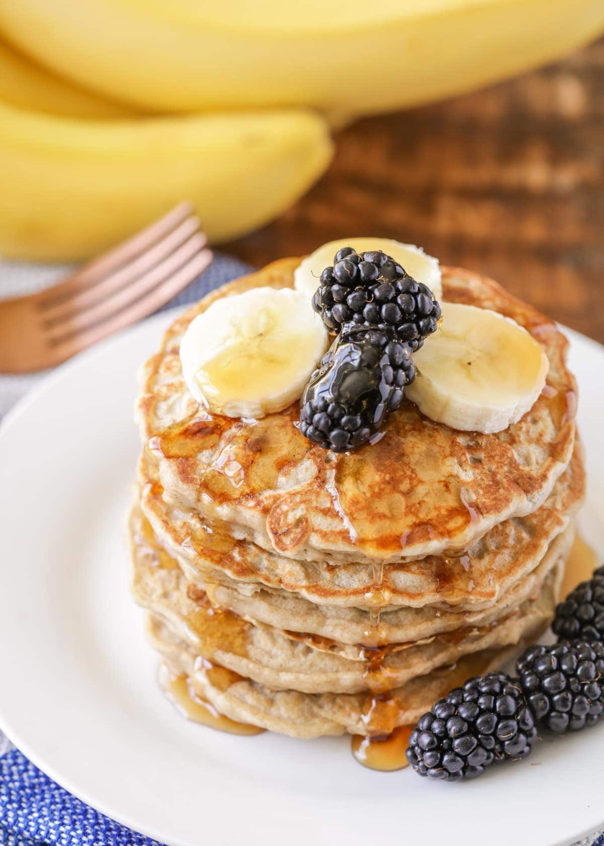 Banana oatmeal pancake recipe with berries and syrup on top