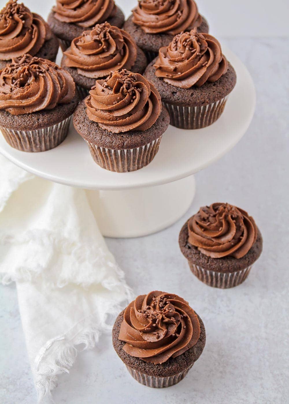 Best chocolate cupcakes on a white cake stand