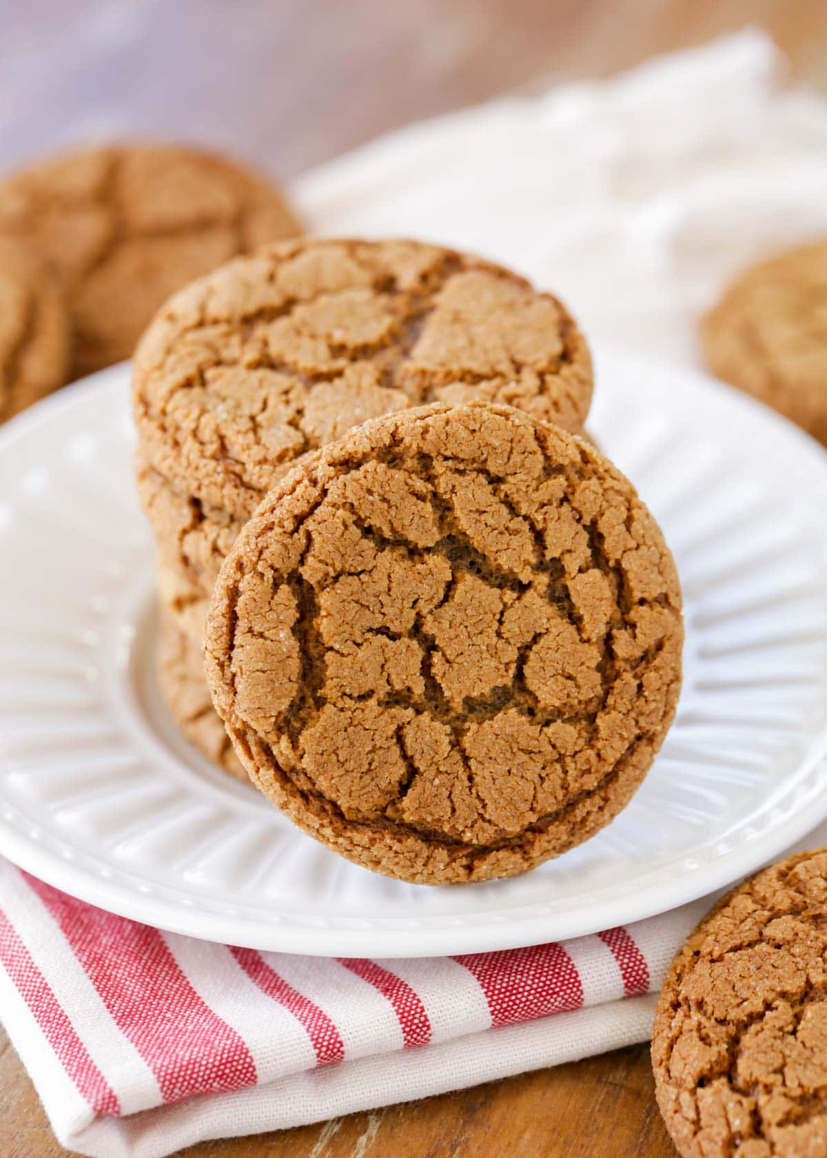Molasses cookies stacked on a white plate