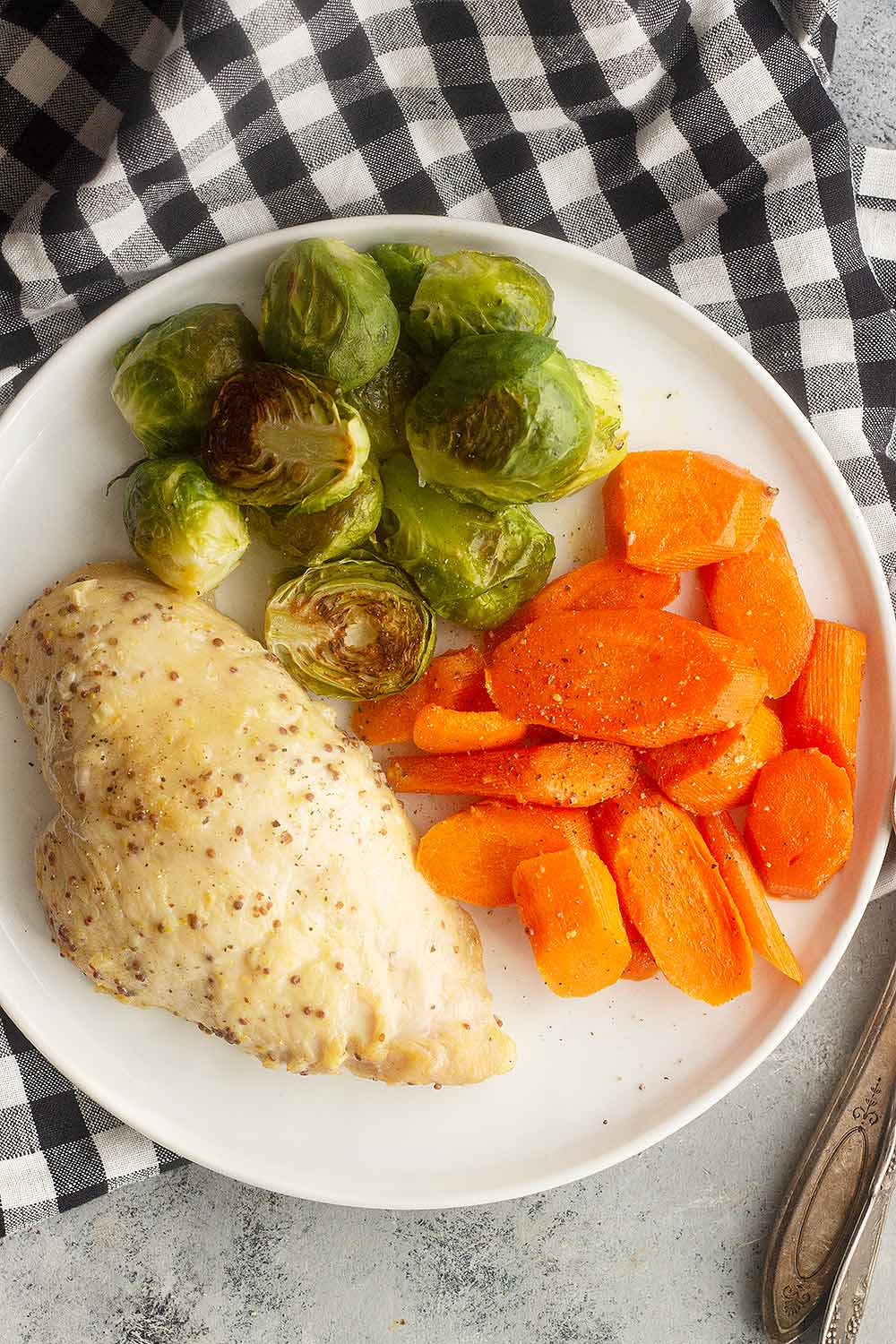 Baked honey mustard chicken on a plate with vegetables